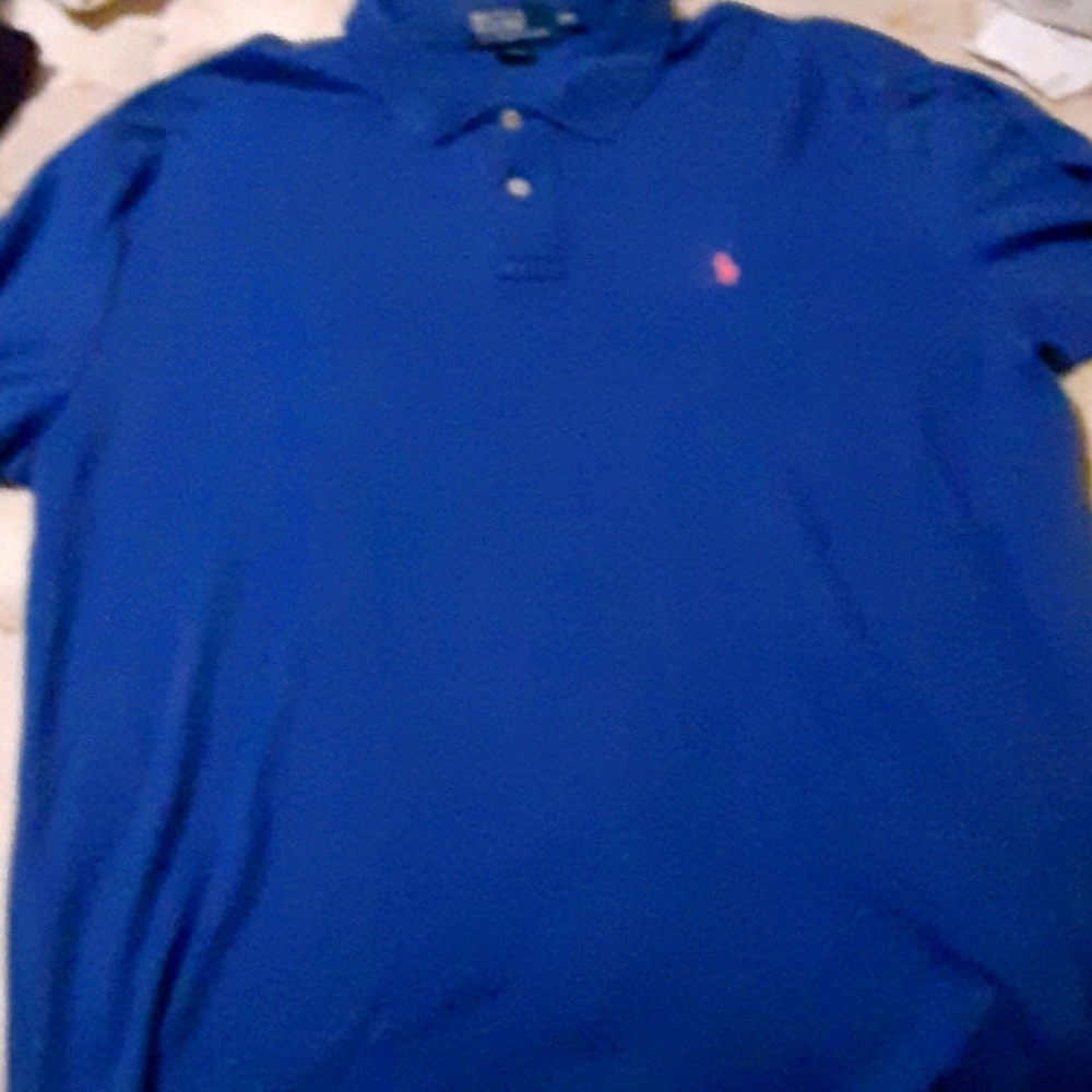 Blue polo by Ralph Lauren with pink symbol